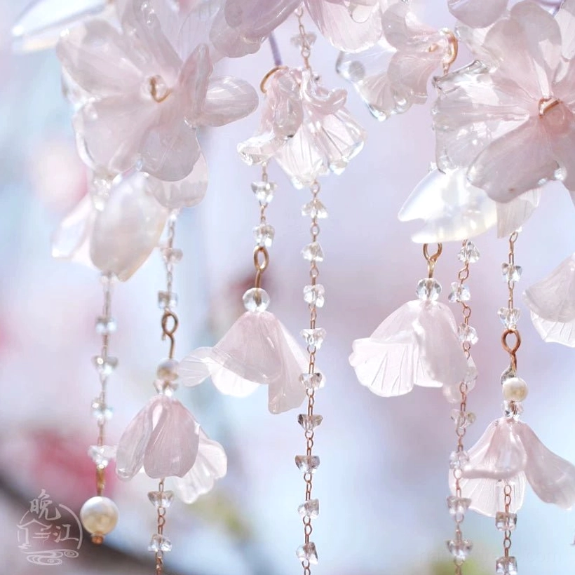 Close-up of a traditional Chinese hair stick with ginkgo leaf pendants pearl ornaments and layered metal tassels for Hanfu hairstyles