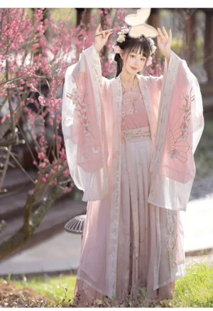 Pink cherry blossom Song Dynasty style hanfu with raised wide sleeves in a traditional garden setting