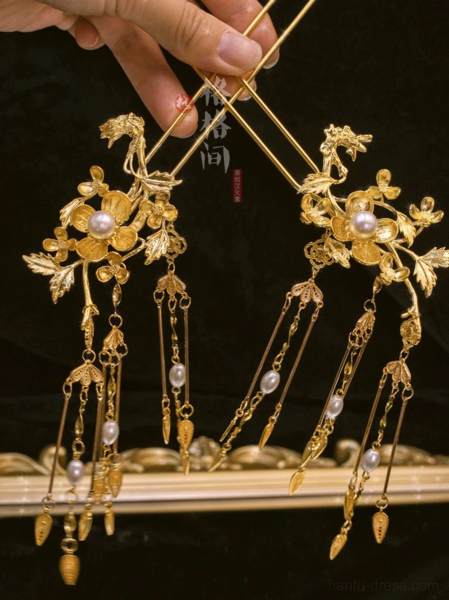 Symmetrical Chinese bridal hair pin set with gilded flowers, leaf motifs, pearl centers, and delicate hanging tassels