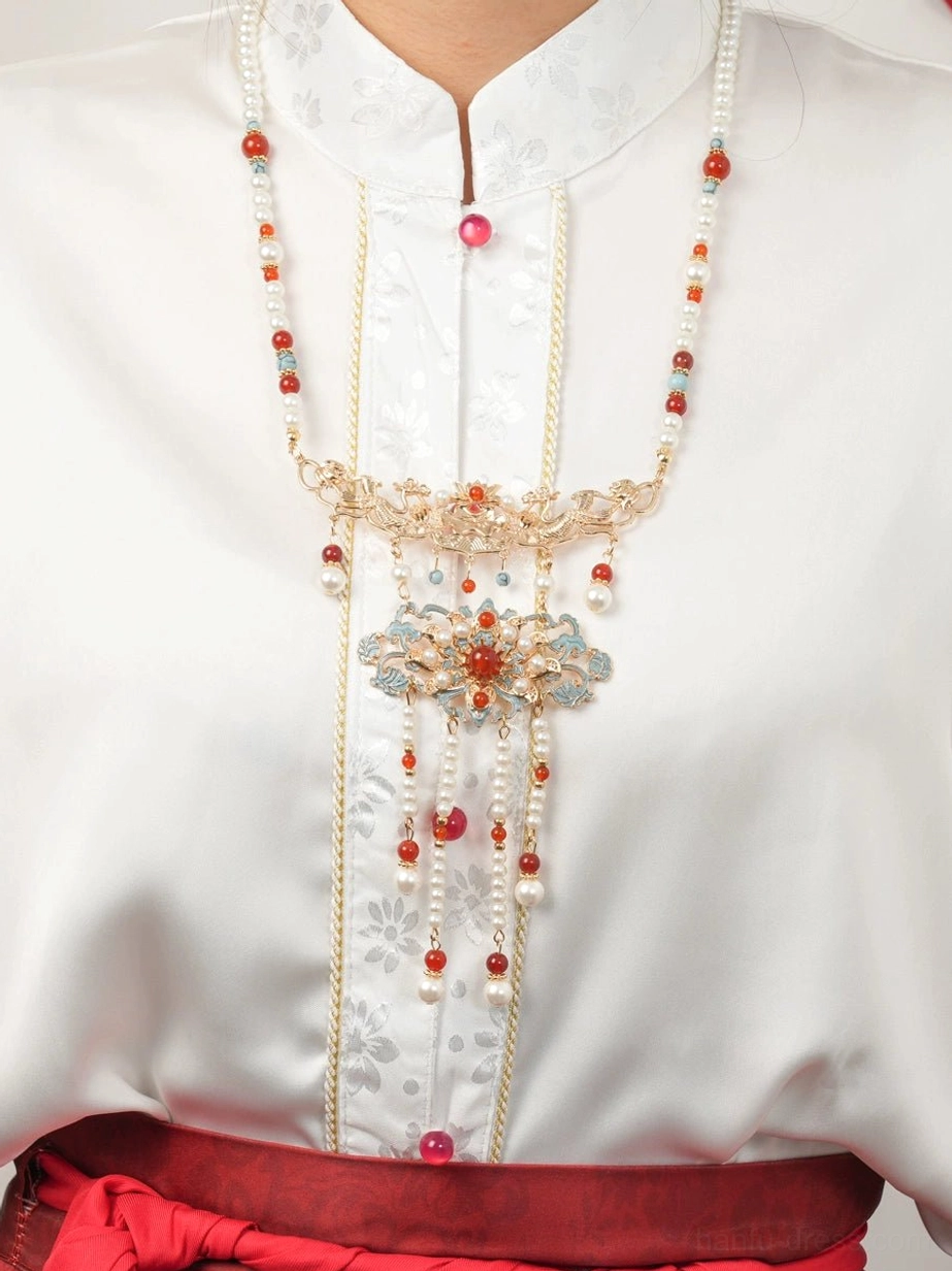 Female model wearing Chinese bridal yingluo necklace with cloisonne floral ornaments over white and red Hanfu wedding clothing