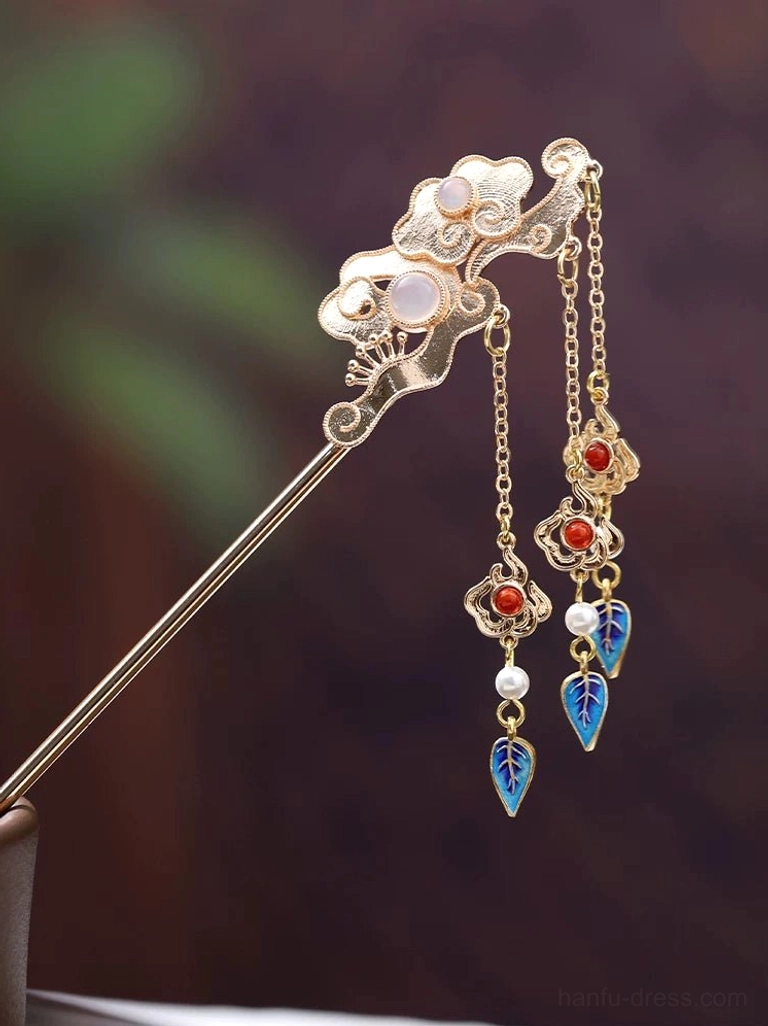 Chinese cloud hair stick with dual hanging tassels, pink inlaid accents, red beads, white pearls, and blue enamel-style leaf charms