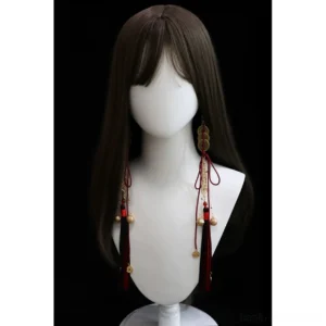 Chinese copper coin tassel ear jewelry displayed on a long black wig mannequin showing red and black tassels, hanging bells, carved pendants, and asymmetrical Hanfu jewelry styling