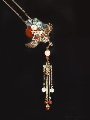 Side view of Chinese crane tassel hair stick showing double-pronged hairpin construction, silver-tone crane motif, floral ornament, and layered bead chain tassels