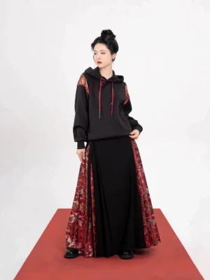 Side view of a Chinese festival hoodie and mamianqun outfit showing red drawstrings and luxurious red-gold brocade skirt panels