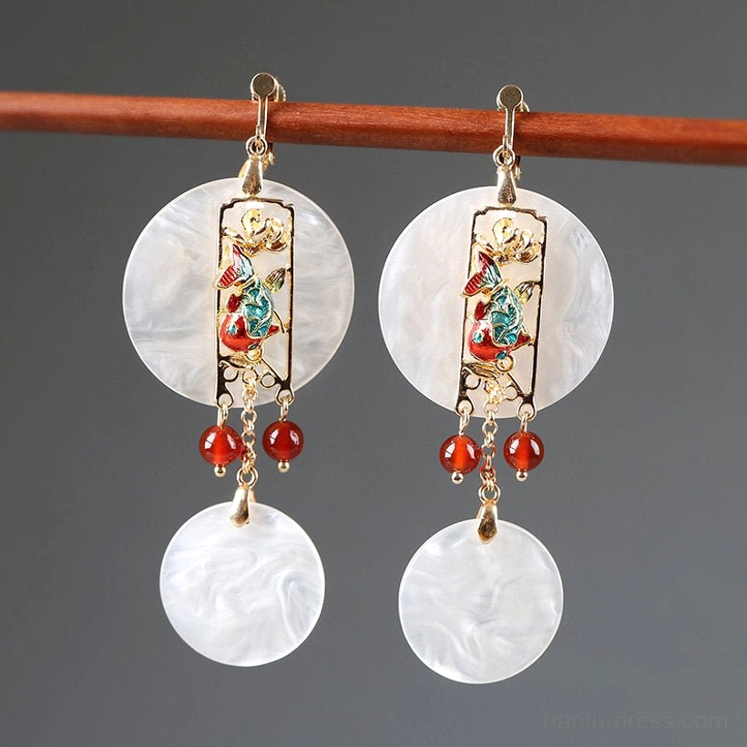 Chinese floral shell clip on earrings hanging on a wooden rod with white pendants gold frame and red bead details