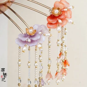 Chinese-style floral tassel hair pin held between fingers showing the double-pronged golden hair stick colorful beads and matching dangling tassels
