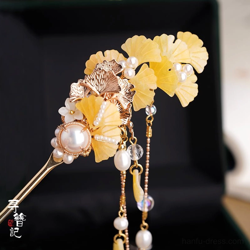 Chinese style ginkgo hairpin displayed in a dark green jewelry box with yellow leaf ornaments, faux pearls, and short decorative tassels