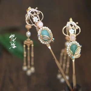 Pair of Chinese green gem pearl tassel hairpins with gold-tone floral metalwork displayed on a dark wooden surface for Hanfu hairstyles