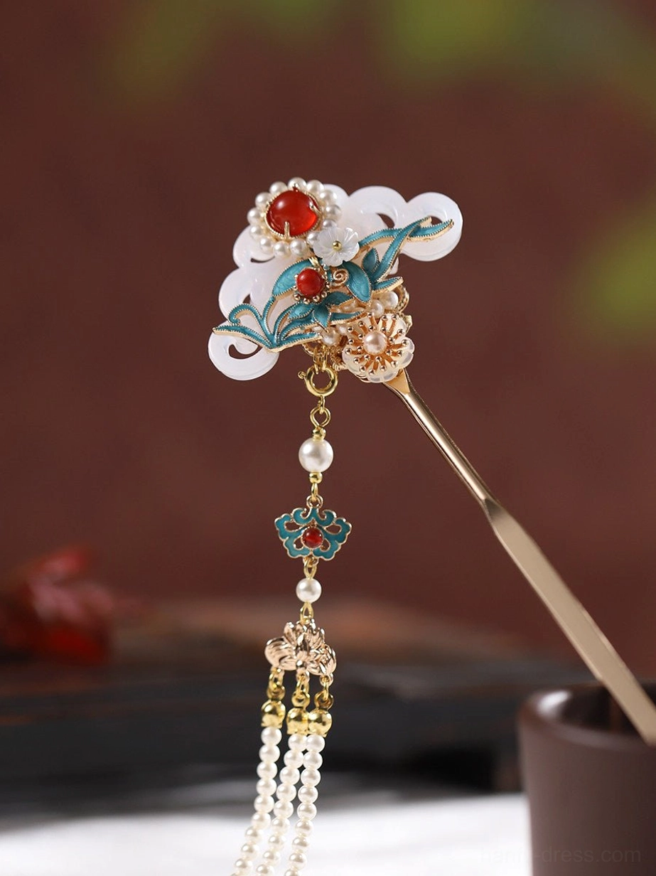 Overhead view of a Chinese hair stick featuring a compact cloud-shaped ornament, double-chain tassel, pearl accents, and gold-tone traditional detailing