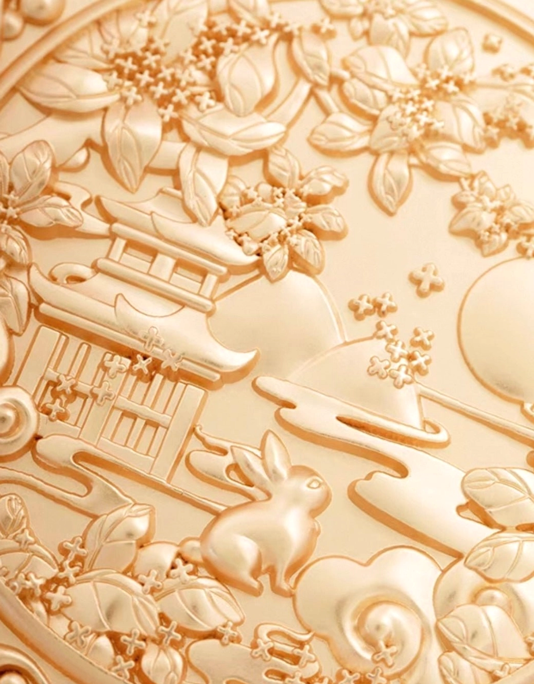 Macro close-up of rose gold Chinese hand mirror relief featuring Jade Rabbit, ancient pavilion, osmanthus flowers, full moon, and drifting clouds