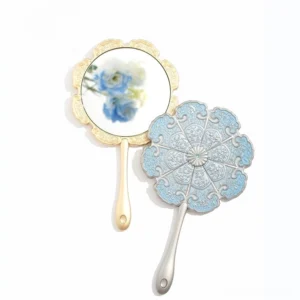 Chinese hand mirror collection displayed on a white background, featuring petal-shaped embossed floral mirror backs with blue enamel-style details and metallic handles
