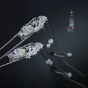 Chinese Hanfu floral tassel hair pin with silver openwork frame iridescent crystal flower and long hanging chain pendants on a dark background