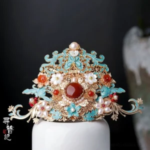 Medium Chinese hanfu hair crown ornament with gold-toned filigree frame, turquoise cloisonne-style details, central red gemstone accent, red beads, and white floral decorations