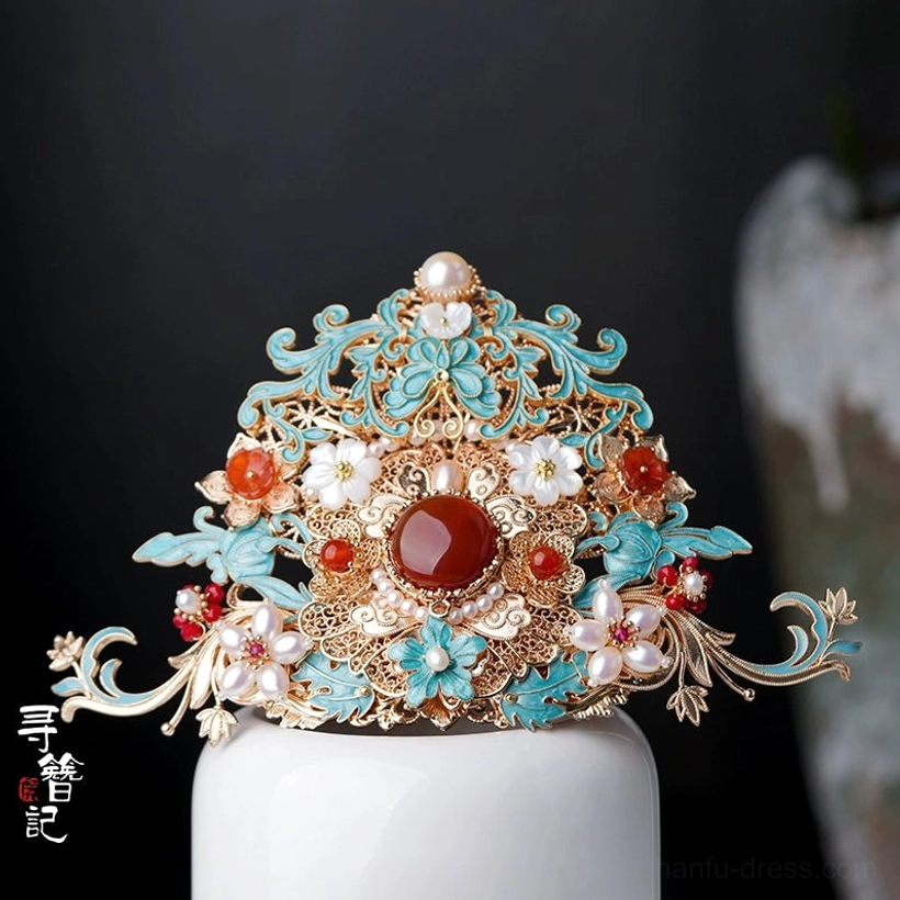 Medium Chinese hanfu hair crown ornament with gold-toned filigree frame, turquoise cloisonne-style details, central red gemstone accent, red beads, and white floral decorations