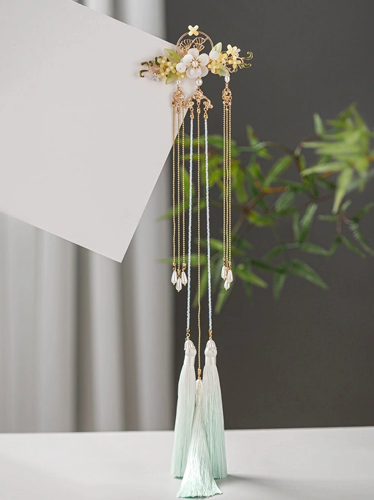 Side display of a short tassel Chinese Hanfu hairpin featuring a gold floral top, layered gold and white chains, and matching light cyan pendant tassels