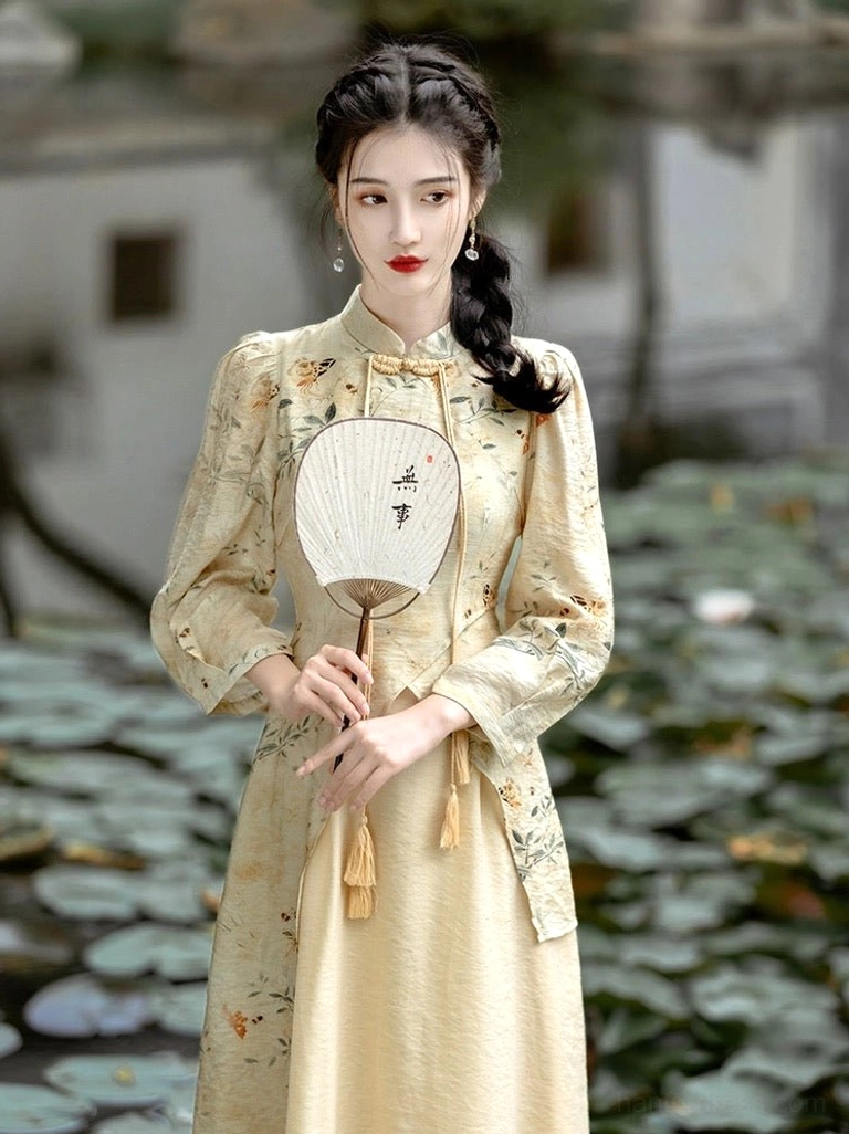 Front view of a Chinese-inspired modern Hanfu cheongsam dress with ink floral print, fitted waist, stand collar, puff sleeves, front tassels, and elegant flowing midi skirt