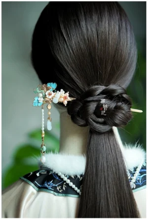 Chinese jade gourd tassel hairpin worn in a traditional coiled Hanfu hairstyle on a vintage doll with embroidered clothing