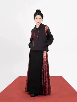Front view of a modern Chinese New Style black hoodie and mamianqun horse face skirt set with red-gold vintage brocade details