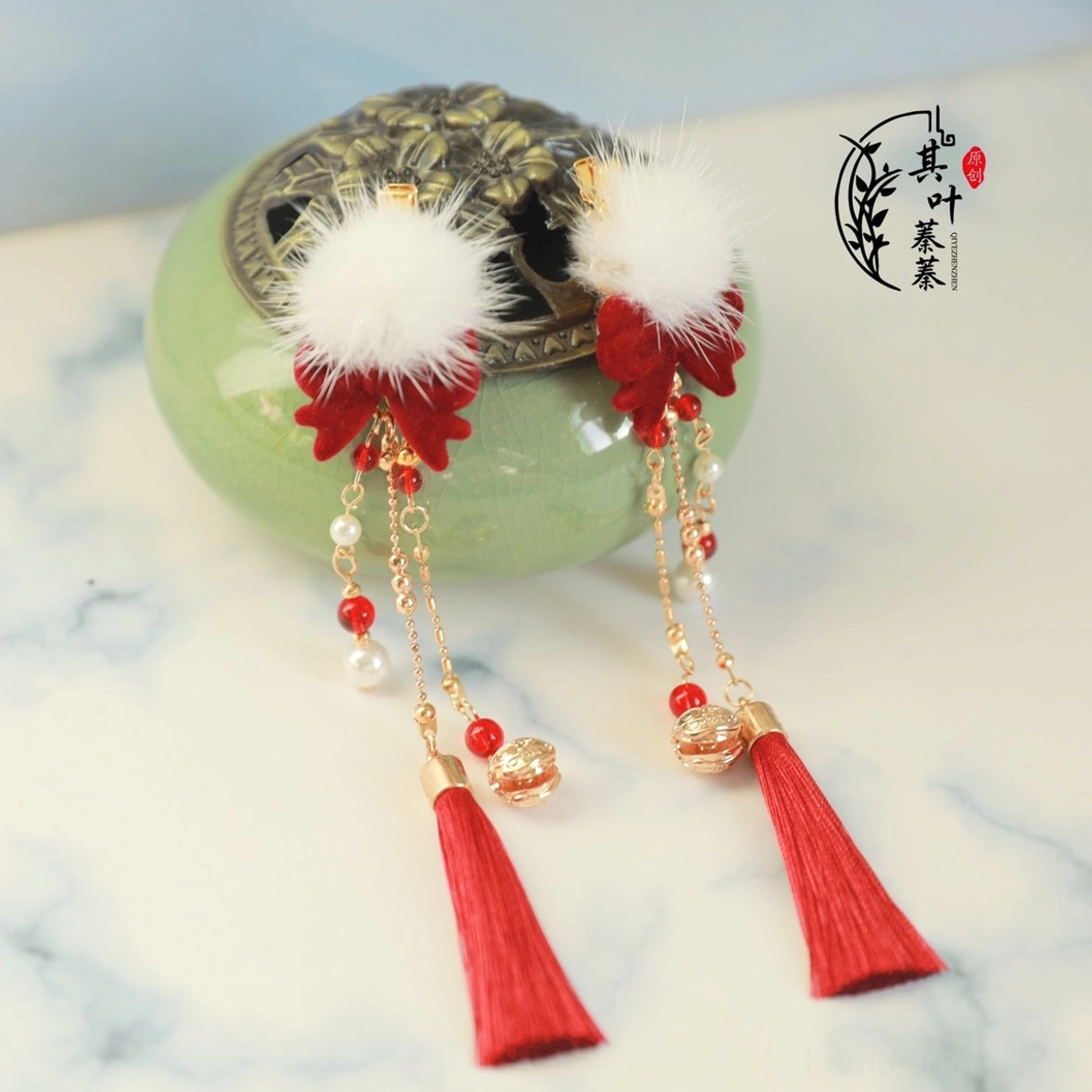 Pair of Chinese New Year Hanfu hair clips with white pom-poms, red silk tassels, red flowers, pearl-like beads and gold-tone chain details