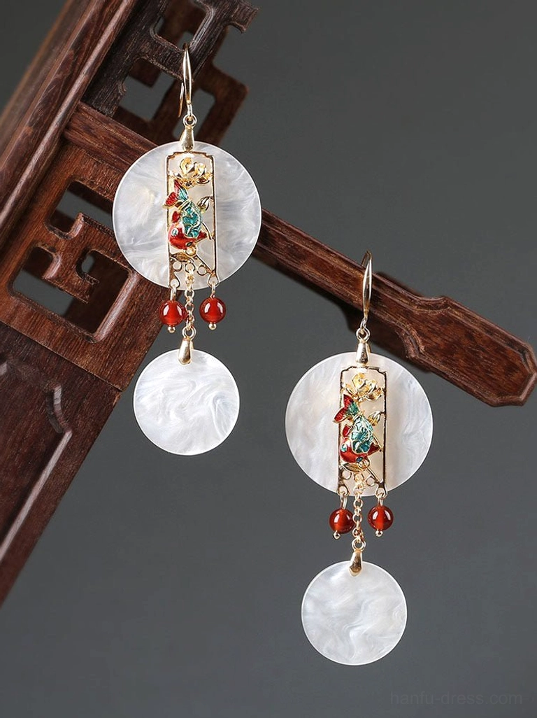 Chinese vintage style shell dangle earrings displayed on carved wooden furniture with layered white shell charms and red agate bead tassels