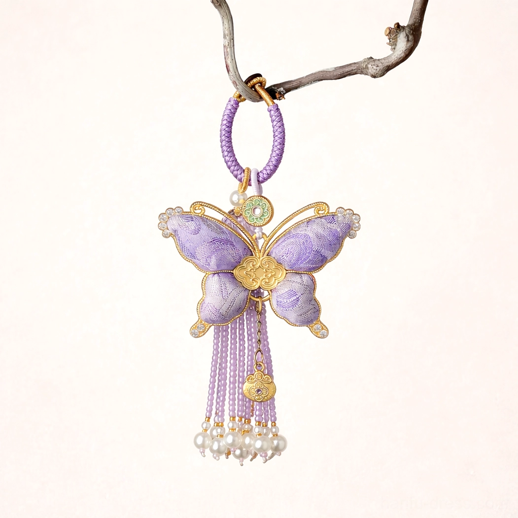 Lavender purple Chinese Song brocade butterfly bag charm and keychain with gold-toned trim, tassels, imitation pearl pendants, colorful beads, and decorative hanging ornament