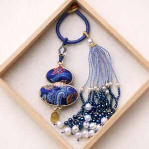Dark blue Chinese Song brocade gourd bag charm keychain with embroidered traditional patterns, blue beaded tassel, pearl-like accents, woven cord, and metal hanging tag
