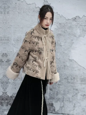 Three-quarter rear view of a relaxed Chinese-style bamboo leaf fuzzy jacket styled with a high-waisted black long skirt and adjustable front tie straps