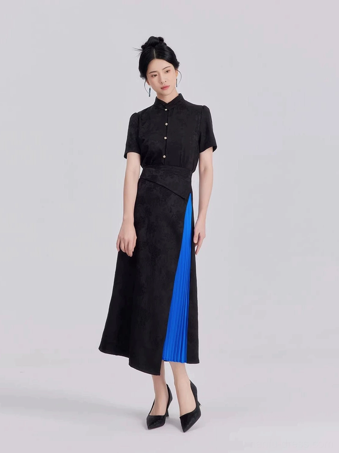 Three-quarter view of contemporary Chinese style Hanfu two-piece outfit with stand collar shirt pearl buttons and asymmetrical black jacquard skirt