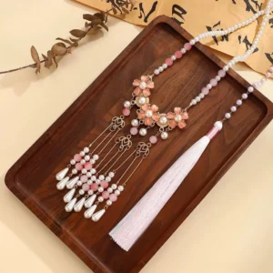 Chinese style Hanfu necklace featuring pink cherry blossom pendants, gold filigree details, pearl beads, layered drop tassels, and a long silk tassel