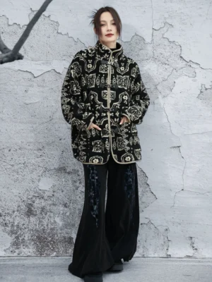 Chinese-style modern Hanfu outer coat with vintage geometric print, traditional frog fasteners, stand collar, and loose silhouette styled with wide-leg black trousers