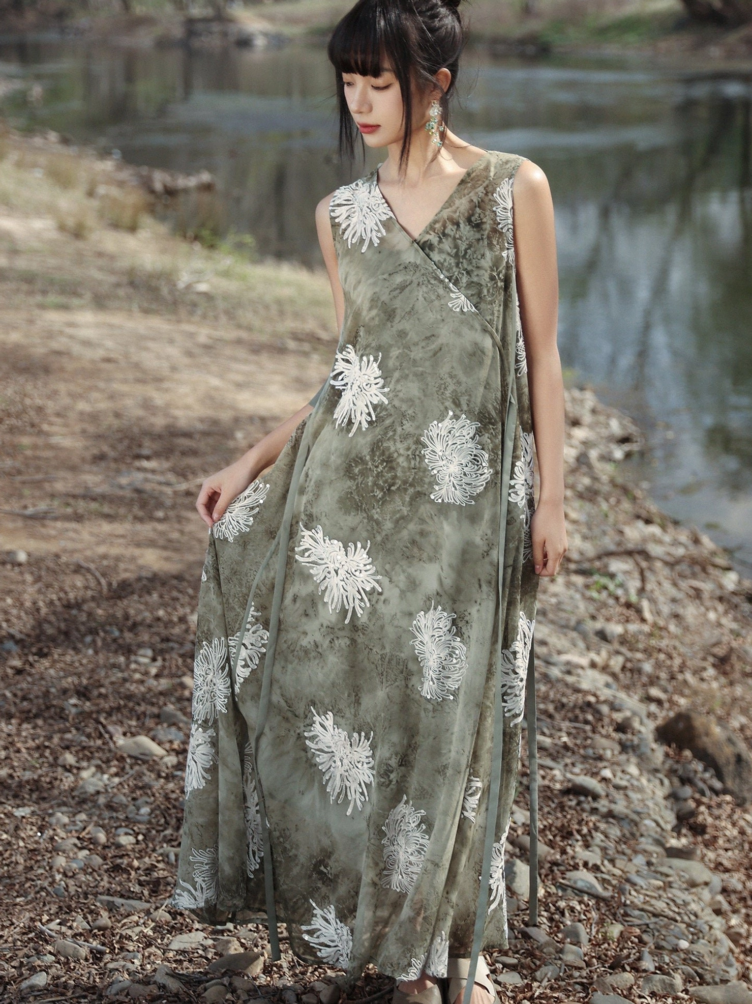 Front side view of a sage green Chinese-inspired tie-dye maxi dress with wrap V-neck, loose A-line shape, and decorative hanging side tie