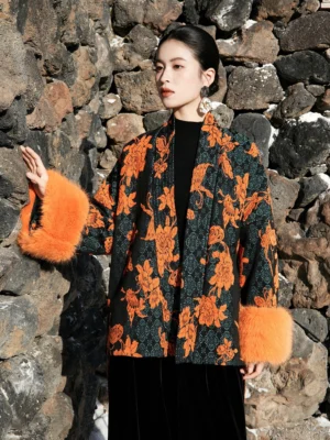 Close half-body view of a Chinese-style wool blend jacquard jacket with open kimono collar, matching waist sash, and contrasting orange fur cuff trim