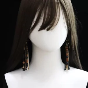 Chinese tassel earrings shown worn on a mannequin with long brown hair displaying the hanging length layered red and black tassels and vintage Hanfu accessory style