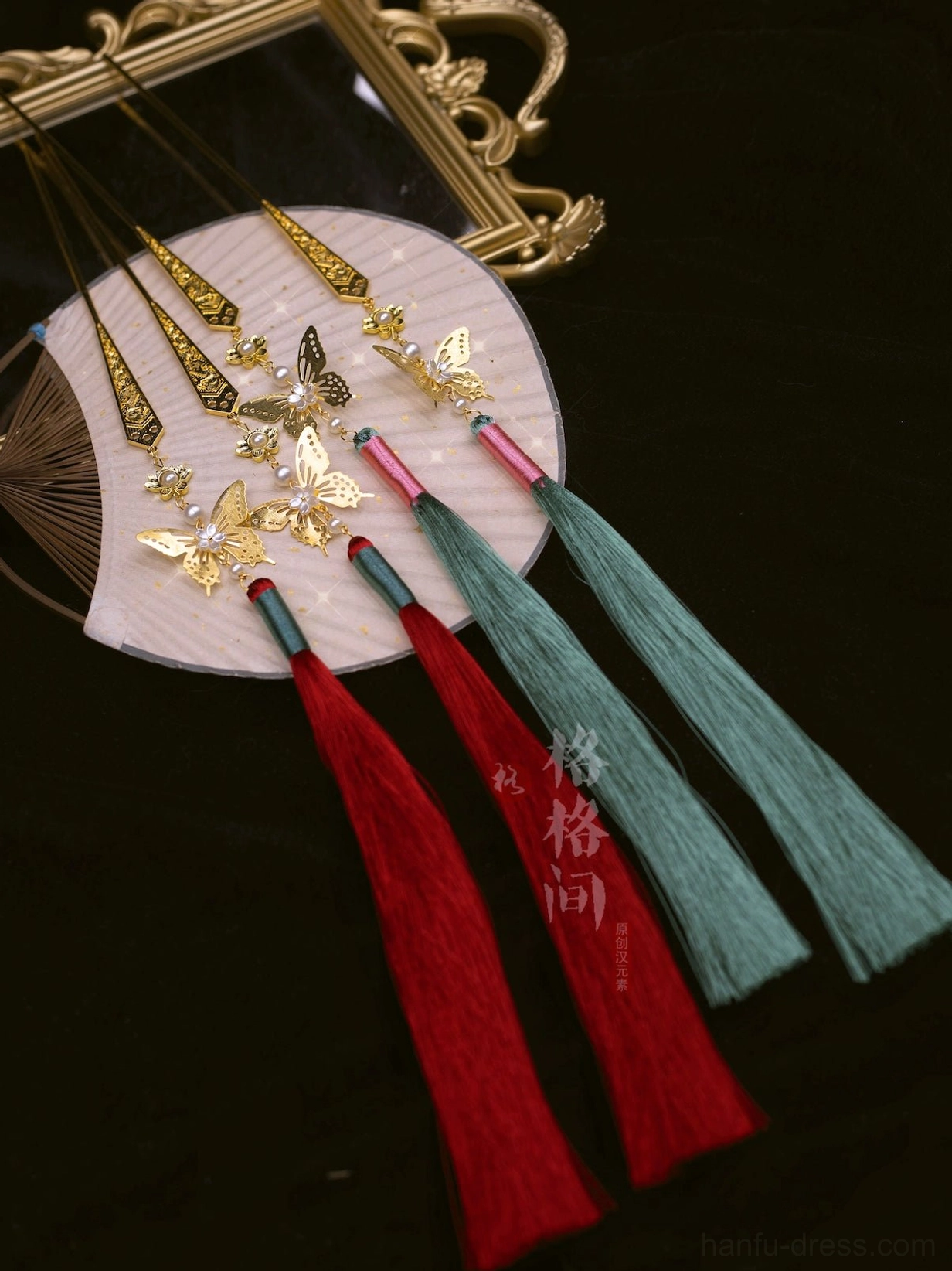 Chinese-inspired red and green tassel hair pin set with long hair sticks and delicate gold butterfly decorations