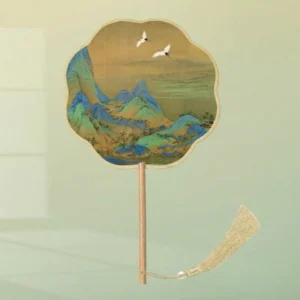 Traditional Chinese tuanshan round hand fan with scalloped plum blossom edge, blue green mountain landscape, white cranes, wooden handle and beige tassel
