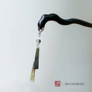 Front view of a handmade Chinese wind chime hair stick with a matte black wavy wooden shaft, gradient green hanging pendants, silver-tone chain, and green bead tassel