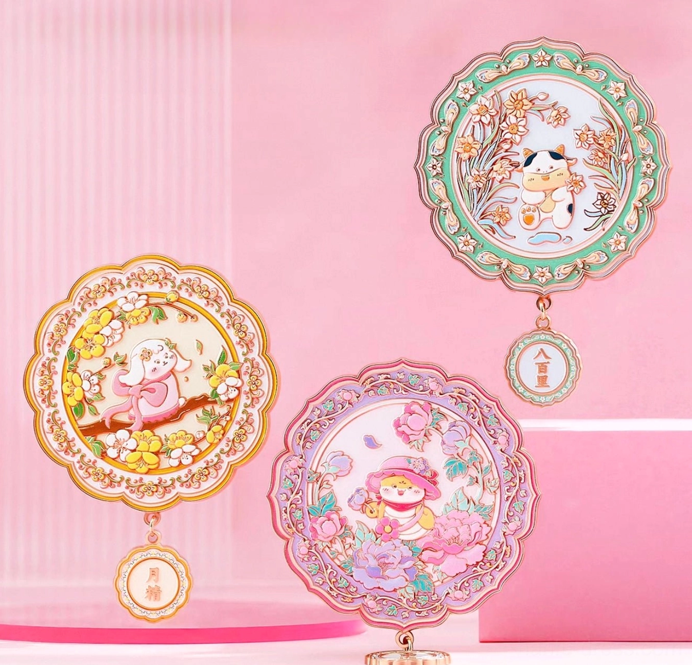 Assorted Chinese zodiac blessings pocket mirrors in colorful animal and floral designs arranged on pink display stands