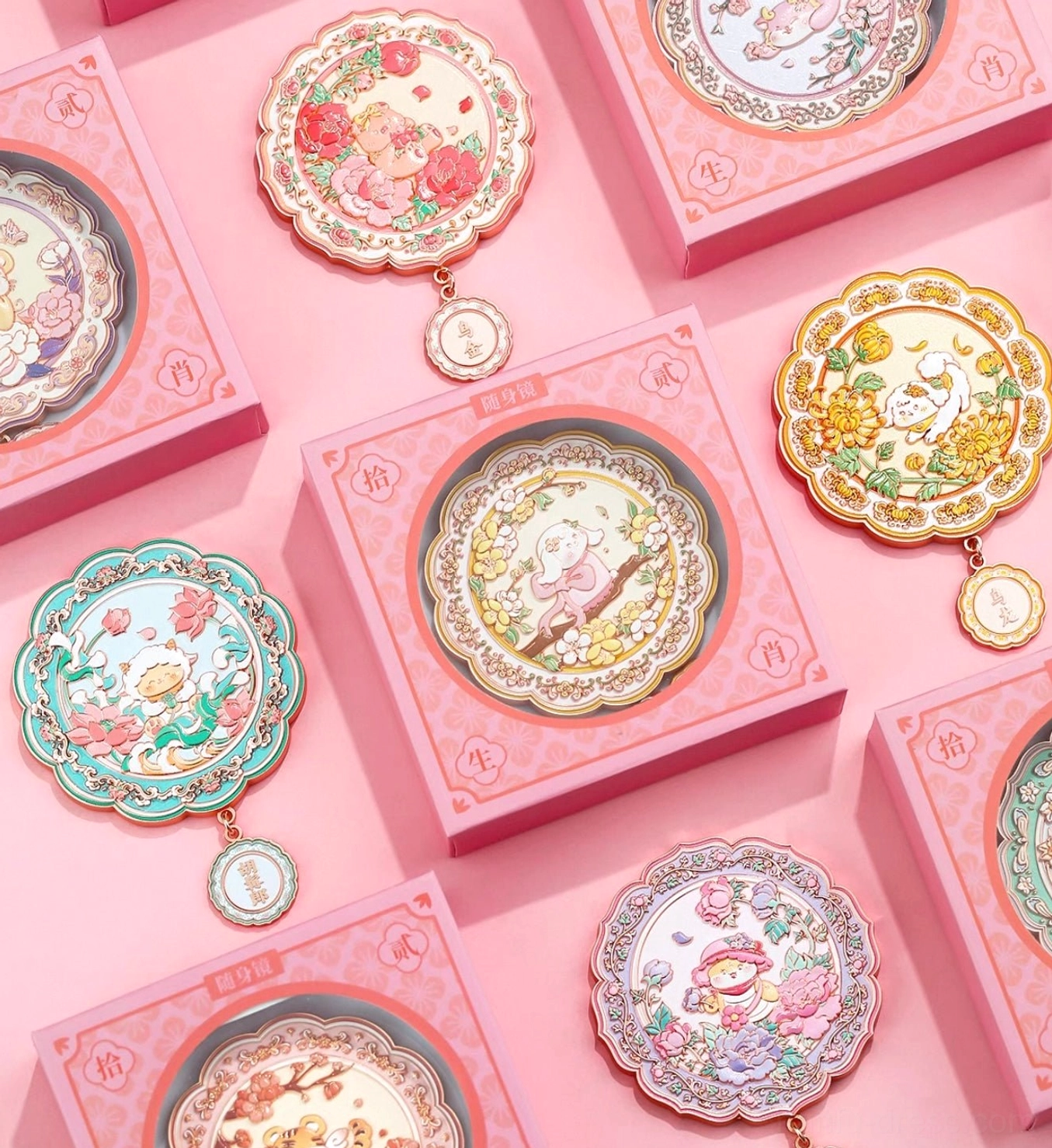 Chinese zodiac blessings pocket mirror collection displayed with pink presentation gift boxes, floral animal designs and hanging zodiac charms