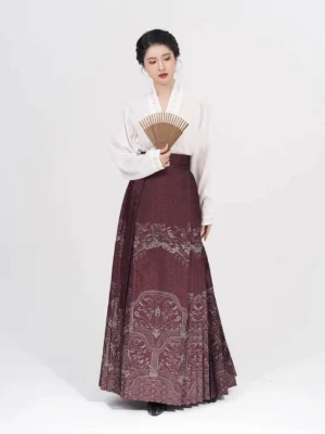 Crimson Ming Dynasty Hanfu mamian skirt styled with a white stand-collar blouse and folding fan in a full-length studio portrait