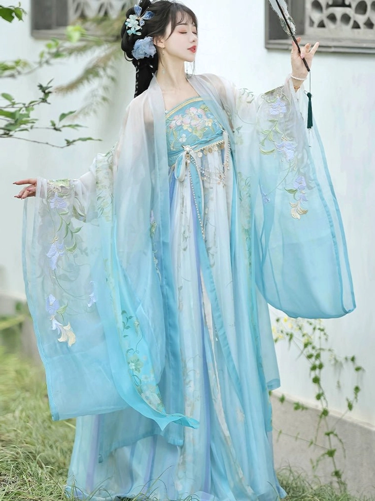 Side view of blue Tang Dynasty Hanfu Heziqun dress set showing the loose flowing silhouette and embroidered wide-sleeved outer robe