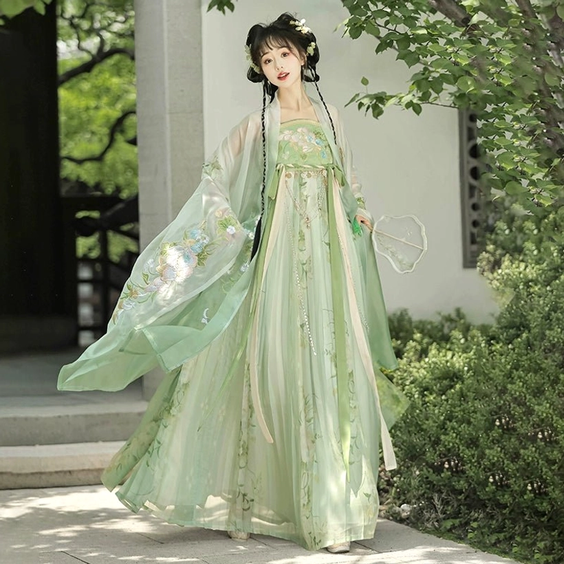 Back three-quarter view of green Tang Dynasty Hanfu Heziqun complete set with flowing embroidered outer sleeves and long dress