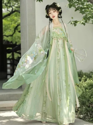 Green Tang Dynasty Hanfu Heziqun dress set with floral embroidery and sheer wide-sleeved outer coat in a classical Chinese garden