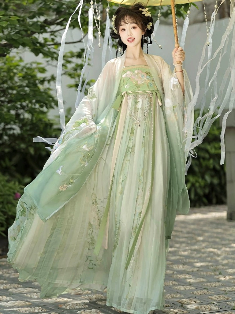 Sage green Tang Dynasty Hanfu Heziqun complete set with floral embroidered dress and lightweight large-sleeved coat on a garden path