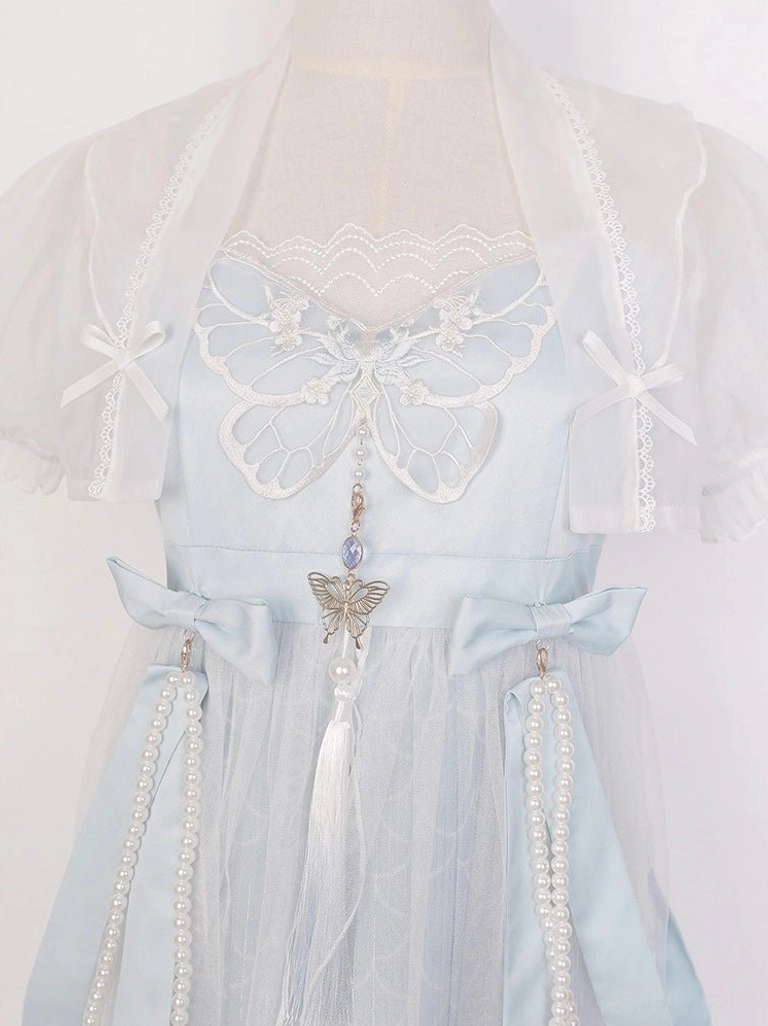 Close-up of butterfly embroidery, lace neckline, pearl chains, bow accents, tassel pendant, and sheer puff sleeve on blue Tang style Hanfu dress