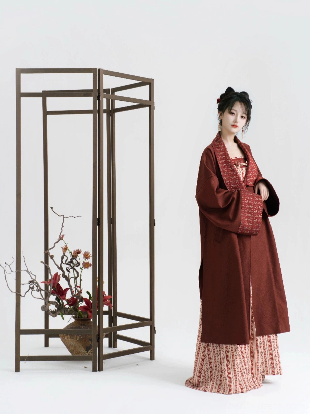 Side view of a model wearing a burgundy and beige modern Hanfu set with a long patterned slip dress