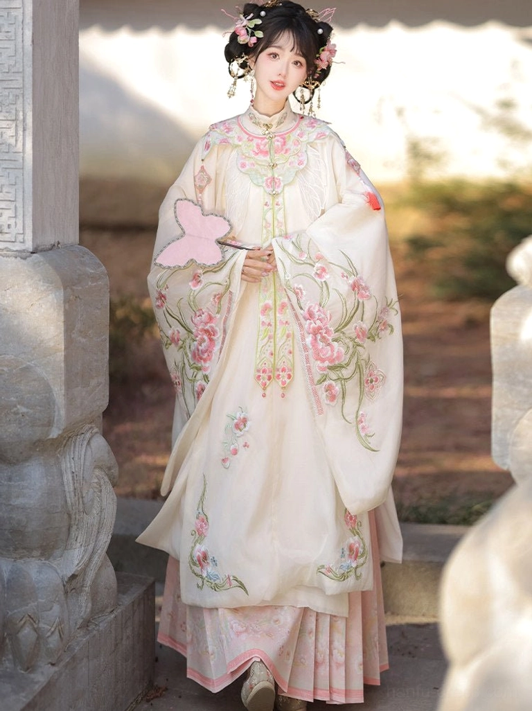 Classic embroidered Ming Dynasty Hanfu outfit with stand collar, floral robe hem, cream top, and matching pink skirt