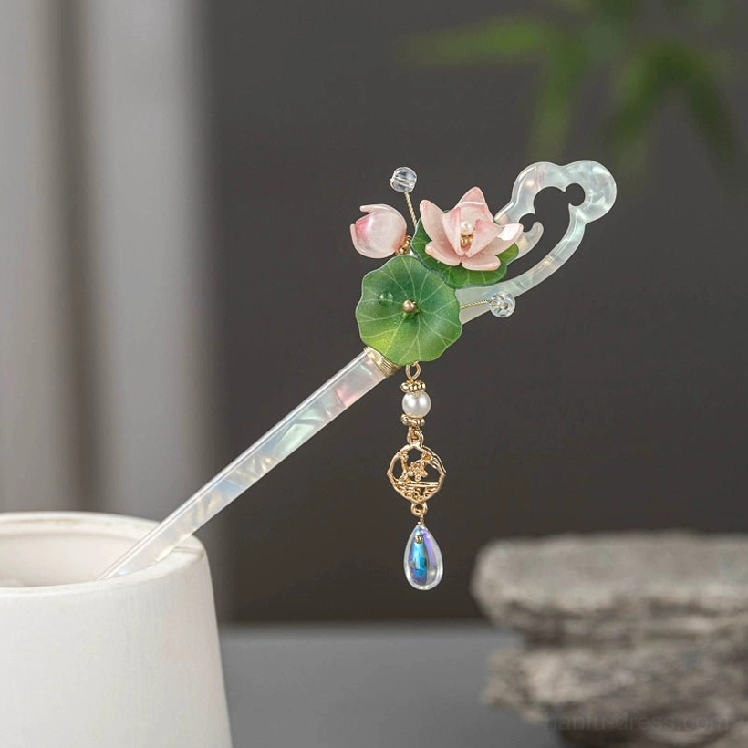 Classical Chinese lotus hair stick shown from the side on a white display stand, with delicate flower decoration and an iridescent dangling charm