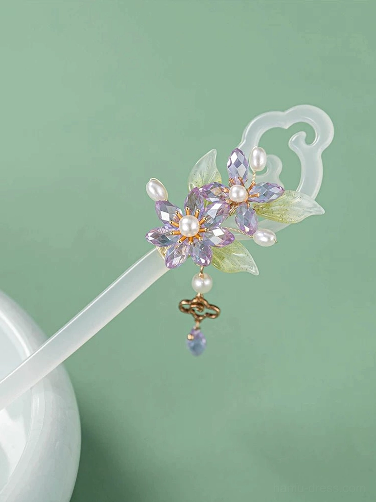 Classical Hanfu hair stick displayed against a light green background with purple flowers, pearl drop, gold cloud charm, blue-purple bead, and milky white stick
