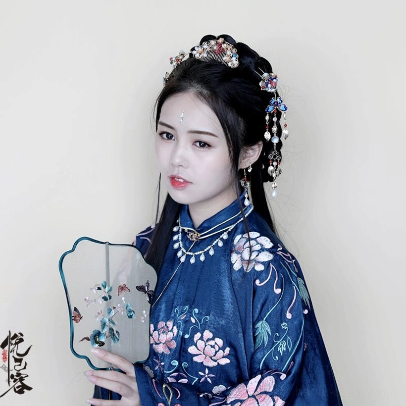 Side view of classical Hanfu hairstyle styled with a Chinese tassel hair pin, pearl pendant, red beads, and traditional dangling ornaments