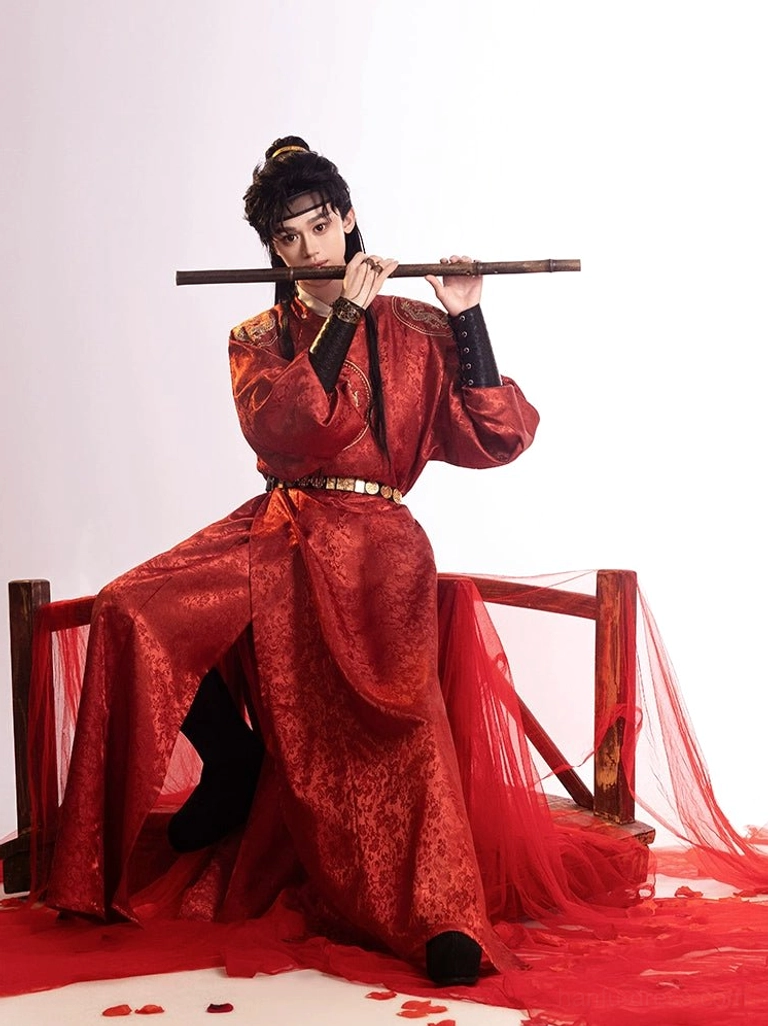 Front seated view of red Tang Dynasty round-collar hanfu robe for men with golden dragon chest design in romantic red drapery studio